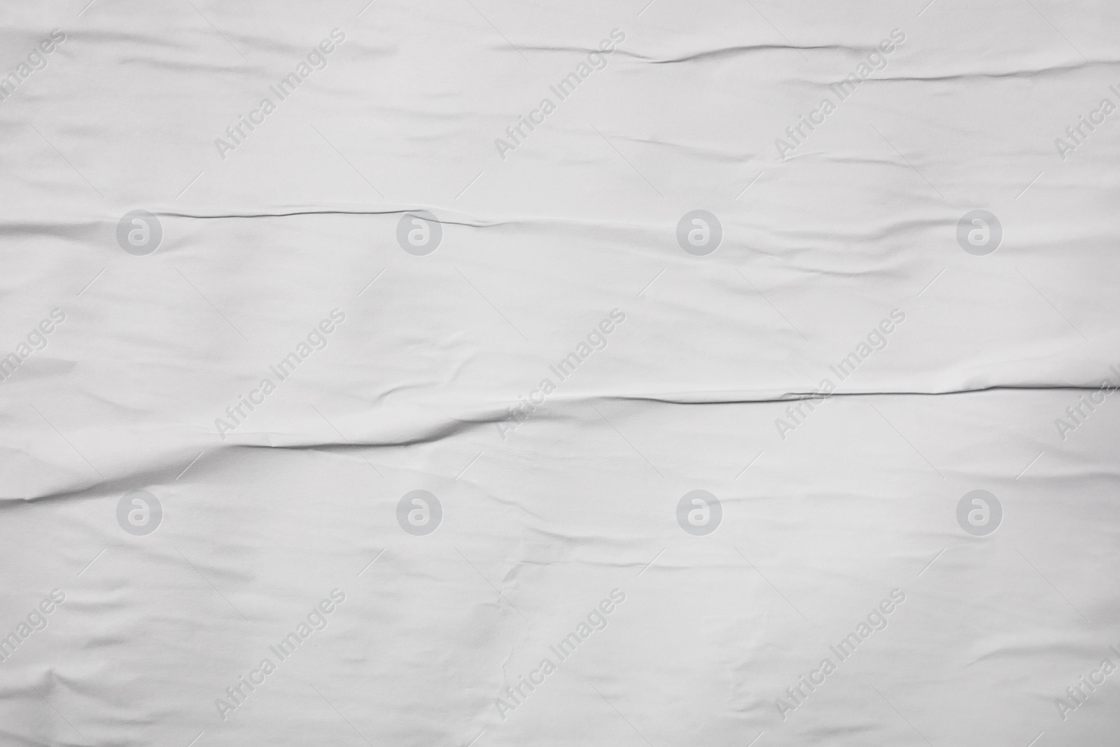 Photo of Top view of white creased blank poster as background, closeup