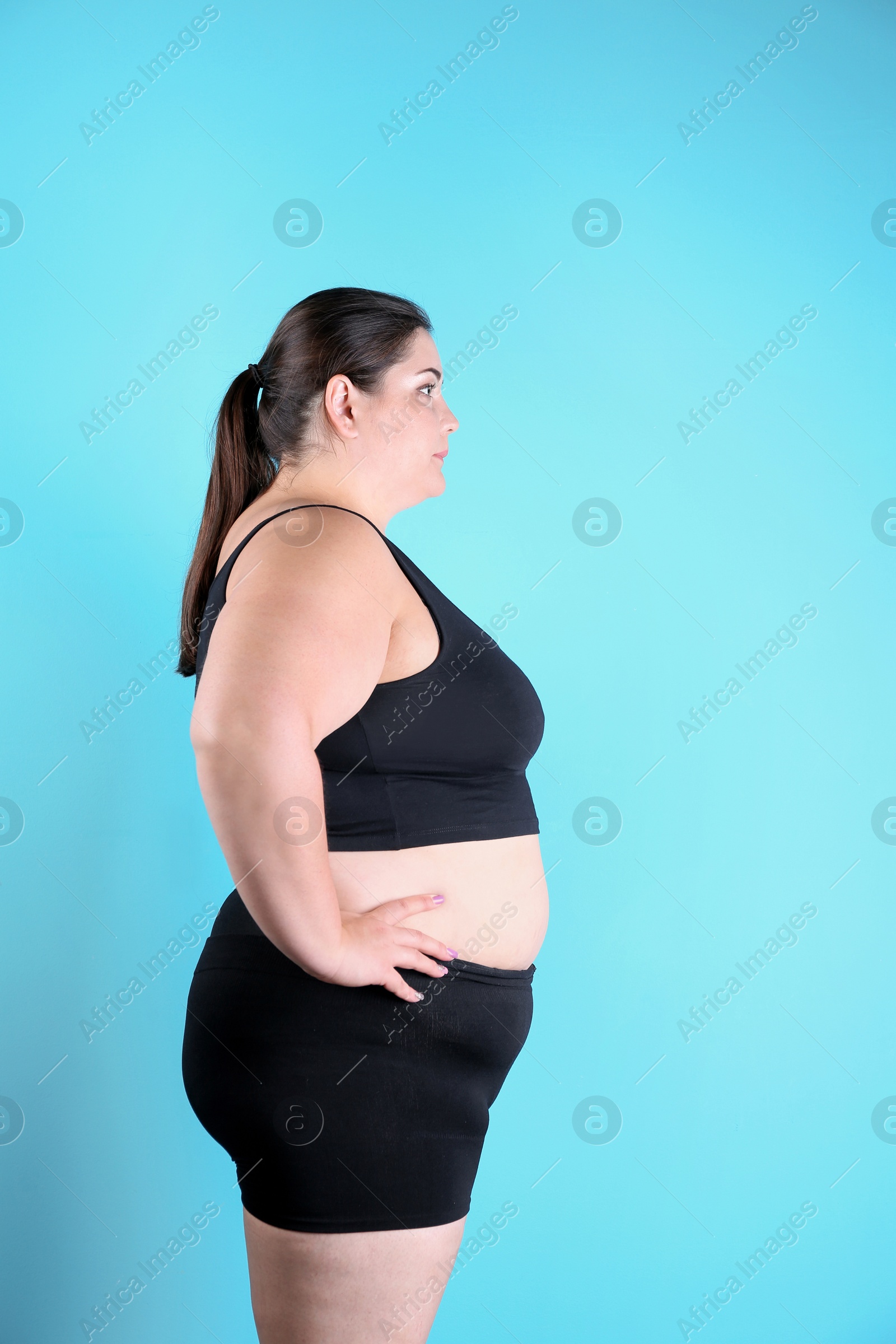 Photo of Overweight woman before weight loss on color background