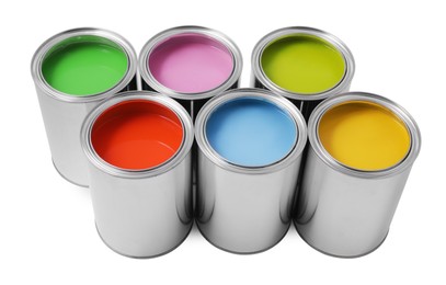 Photo of Cans of different paints on white background