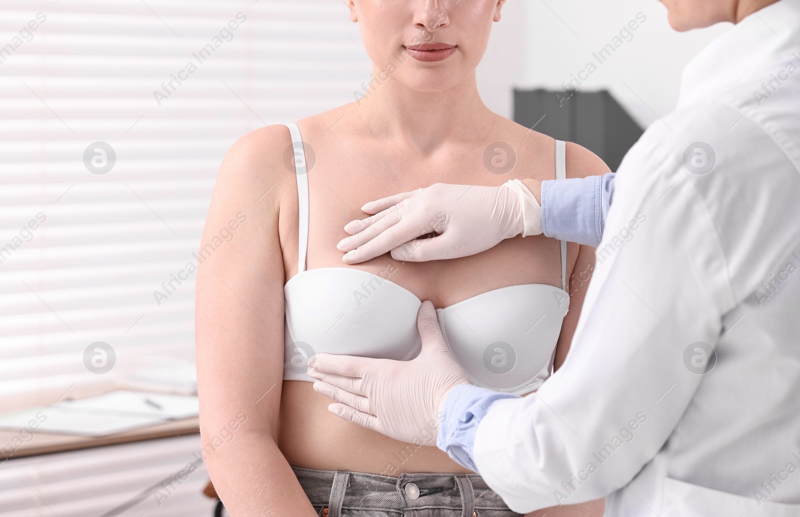 Photo of Mammologist checking young woman's breast in hospital