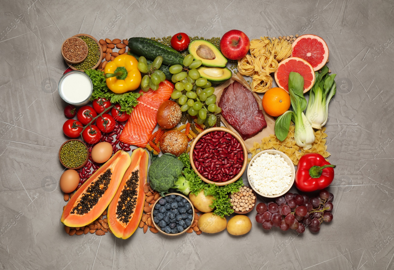 Photo of Different products on grey table, top view. Healthy food and balanced diet