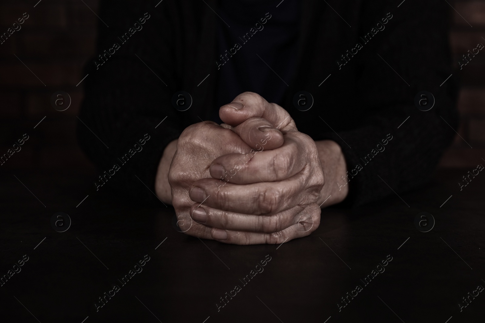 Photo of Poor mature woman at table, closeup of hands