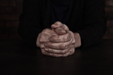 Photo of Poor mature woman at table, closeup of hands