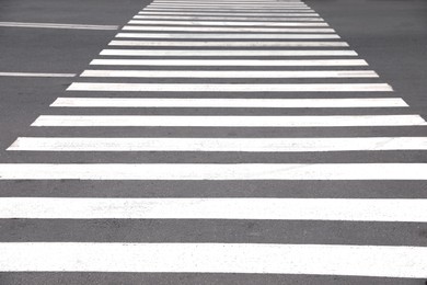 Photo of White pedestrian crossing on empty city street