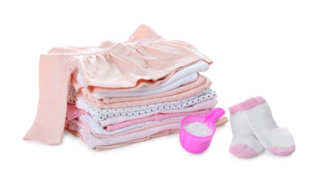 Detergent and children's clothes on white background