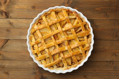 Tasty homemade quince pie on wooden table, top view