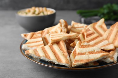 Delicious pita chips on grey table, closeup