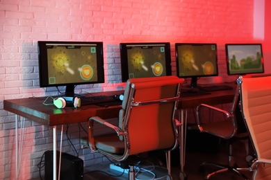 Photo of Internet cafe with modern computers for playing video games