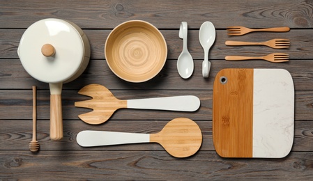 Photo of Set of modern cooking utensils on wooden table, flat lay