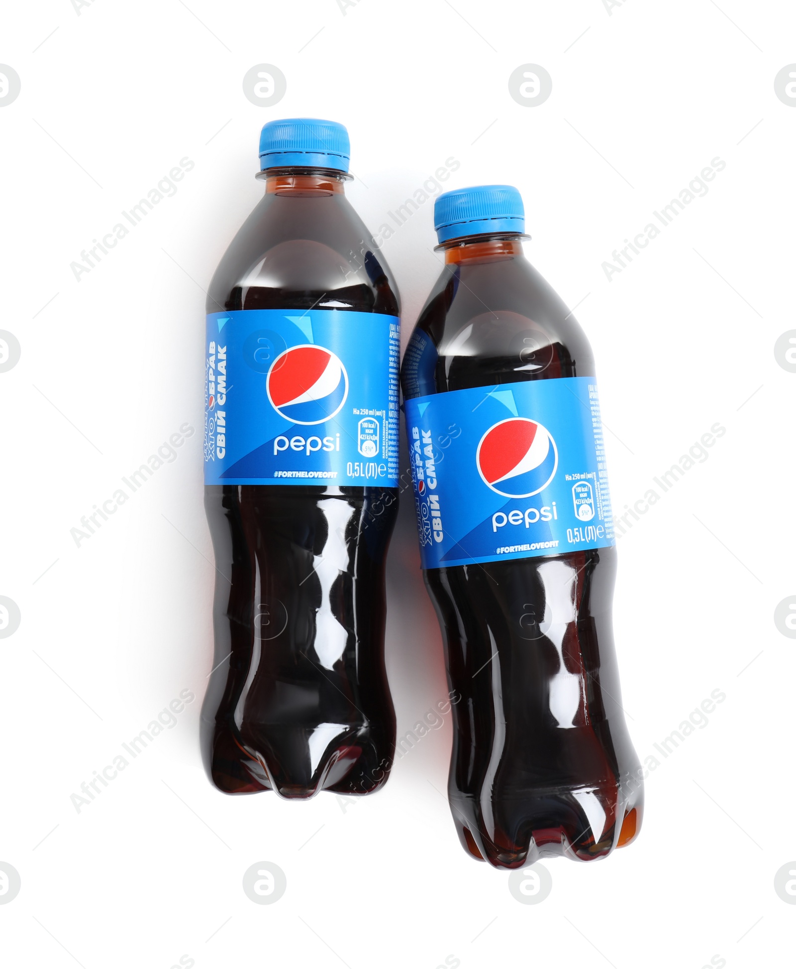 Photo of MYKOLAIV, UKRAINE - FEBRUARY 10, 2021: Bottles of Pepsi on white background, top view