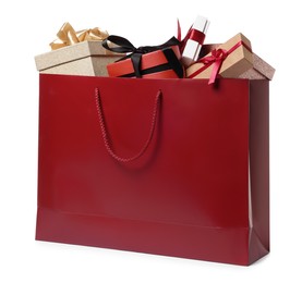 Dark red paper shopping bag full of gift boxes on white background