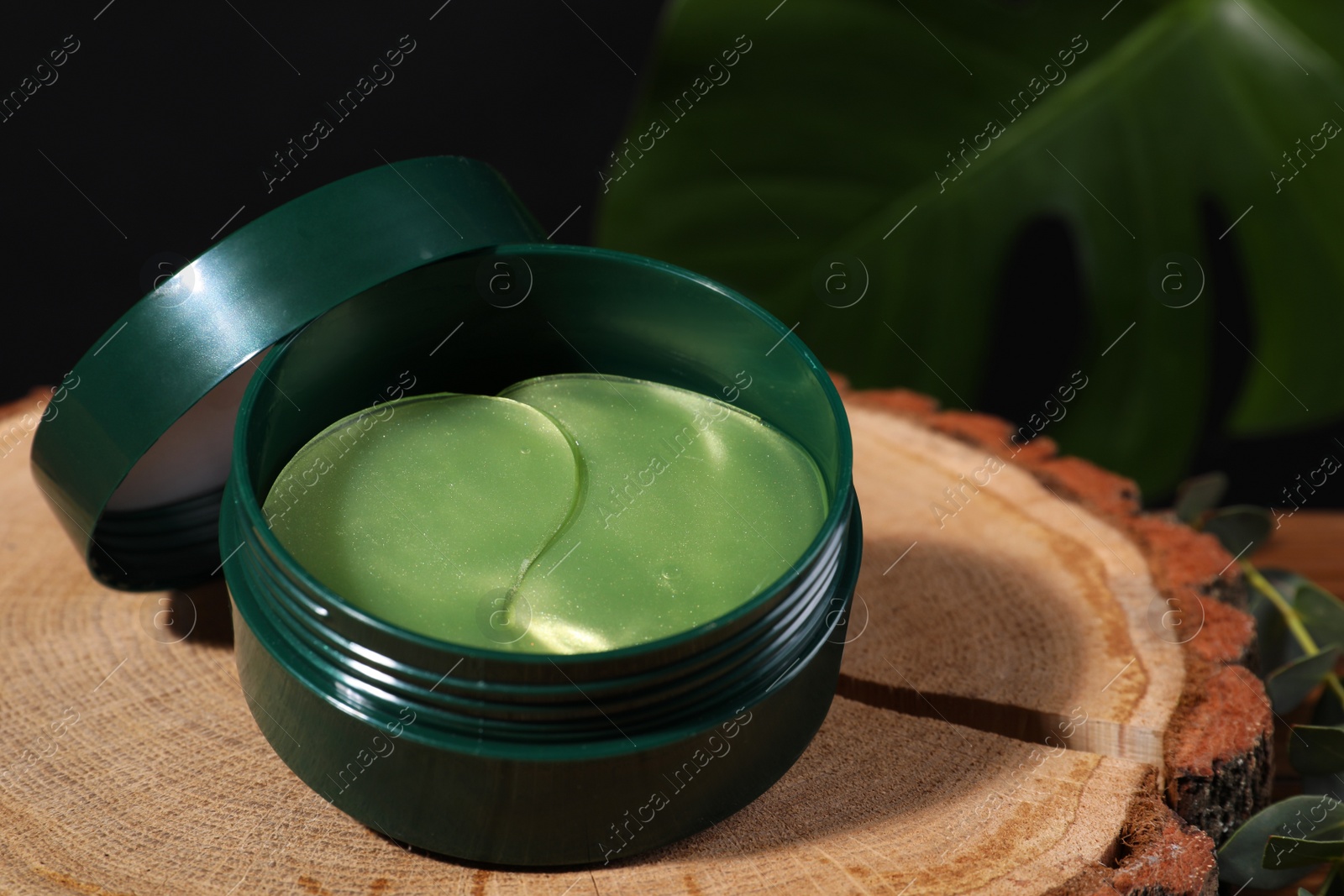 Photo of Package of under eye patches on stump. Cosmetic product, closeup