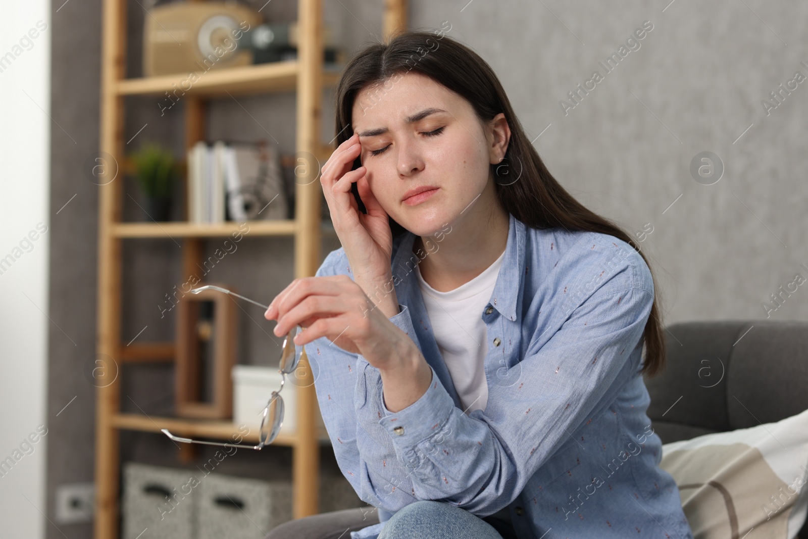 Photo of Overwhelmed woman with glasses suffering at home