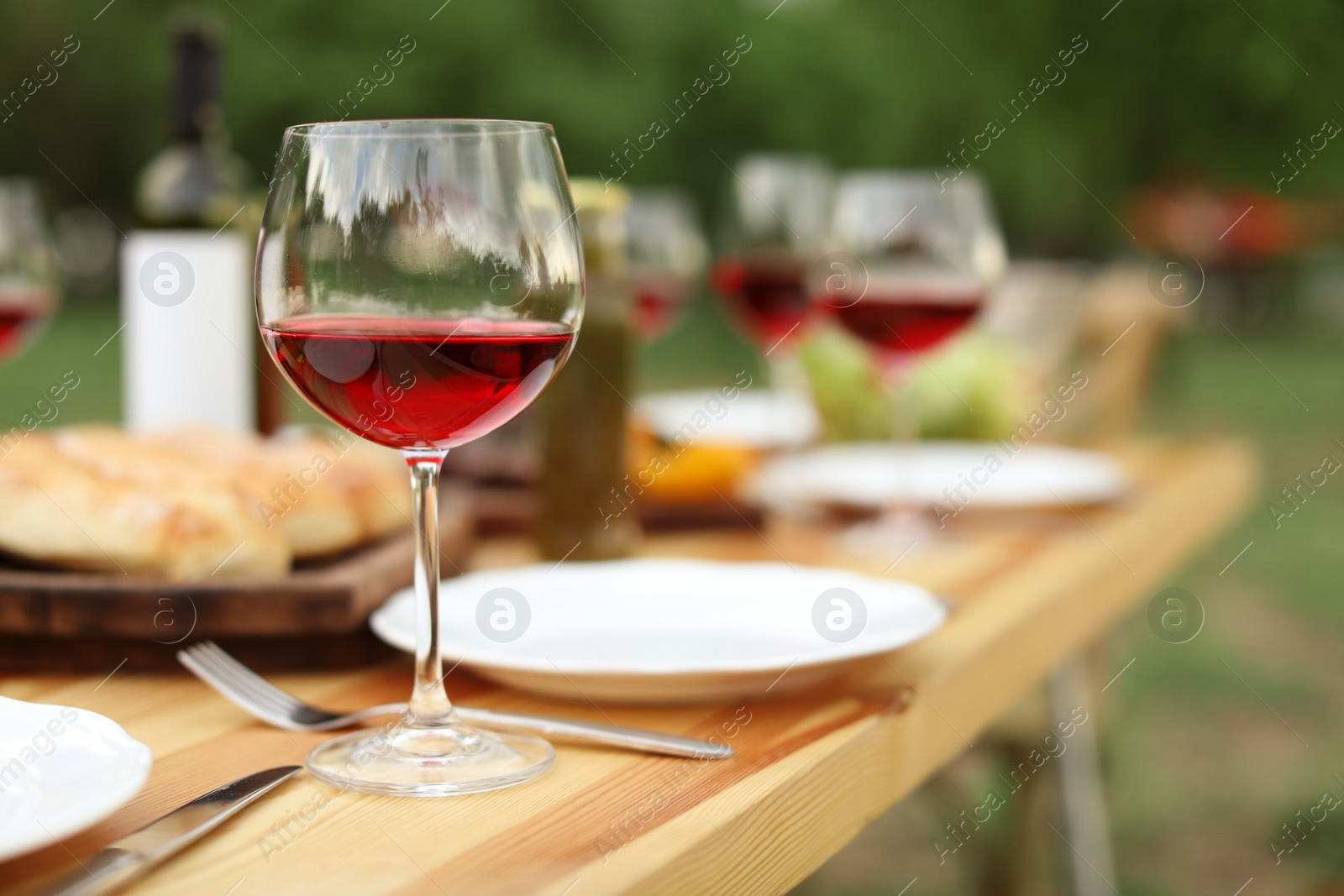 Photo of Table set for barbecue party in countryside