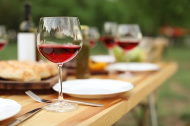 Photo of Table set for barbecue party in countryside