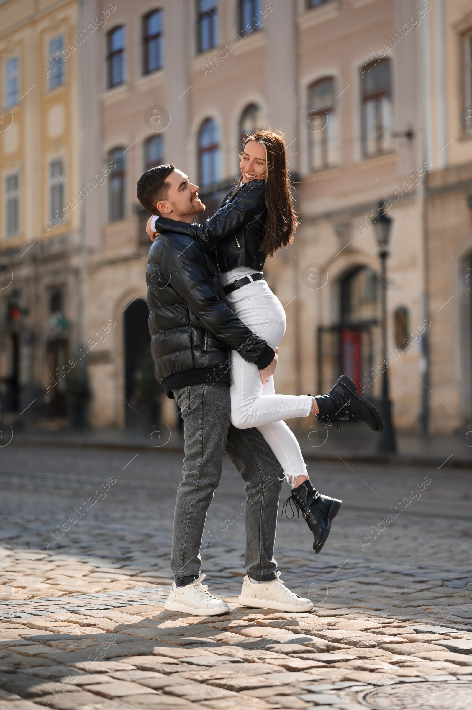 Photo of Lovely young couple having fun together on city street. Romantic date