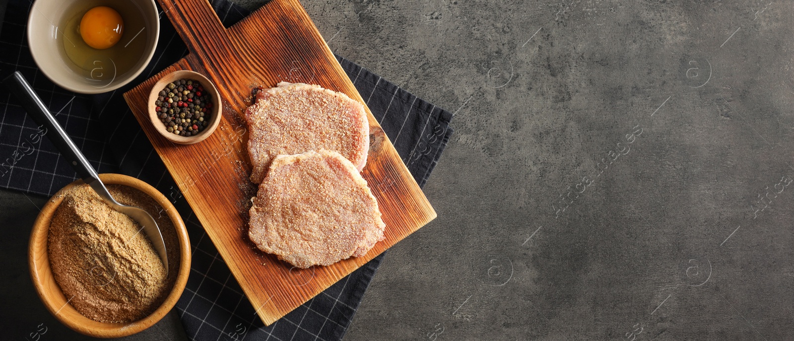 Image of Cooking schnitzel. Different ingredients on grey table, flat lay. Banner design with space for text