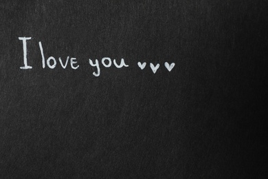 Phrase I Love You on black background. Space for text