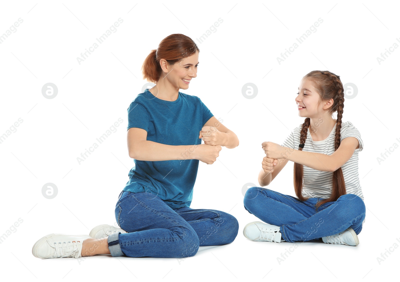 Photo of Hearing impaired mother and her child talking with help of sign language on white background