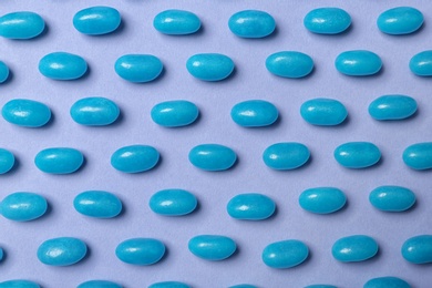 Photo of Many delicious jelly beans on color background, flat lay