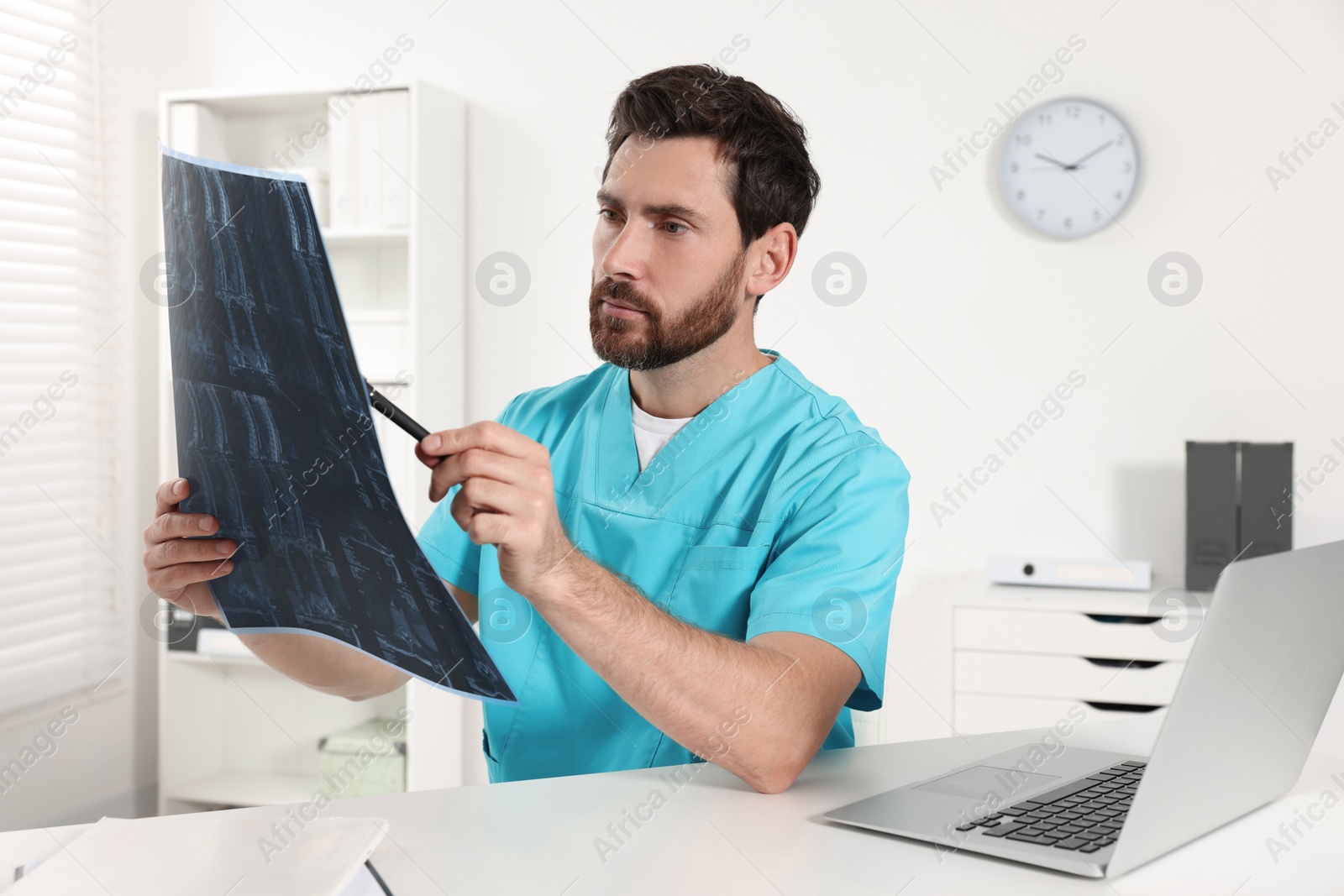 Photo of Doctor examining neck MRI scan in hospital