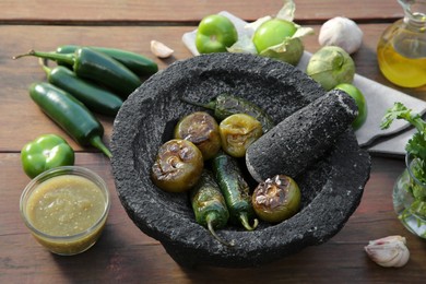 Photo of Different ingredients for cooking tasty salsa sauce on wooden table, above view