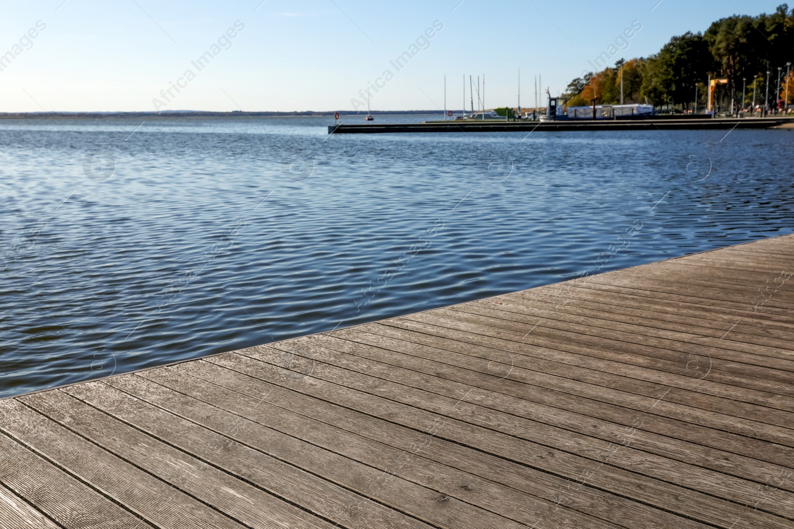 Photo of Beautiful view of wooden terrace near river on sunny day