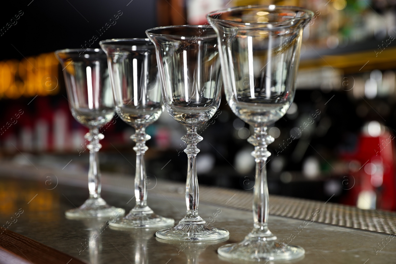 Photo of Row of empty clean glasses on counter in bar