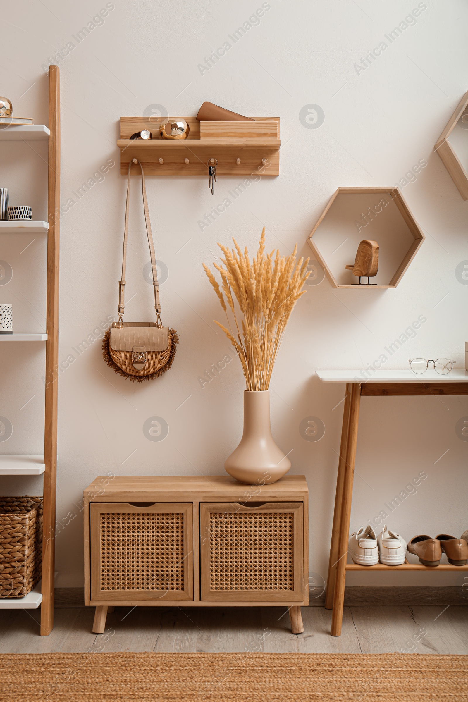 Photo of Stylish hanger for keys on white wall in hallway