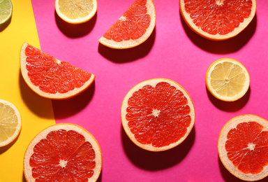 Photo of Flat lay composition with tasty ripe grapefruit slices on color background