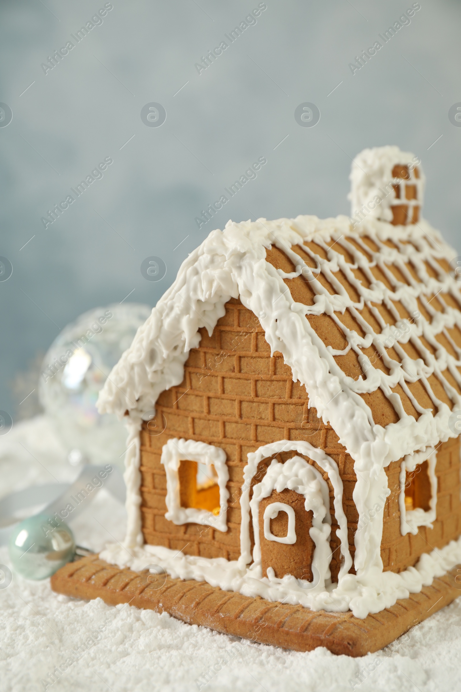 Photo of Beautiful gingerbread house decorated with icing on snow