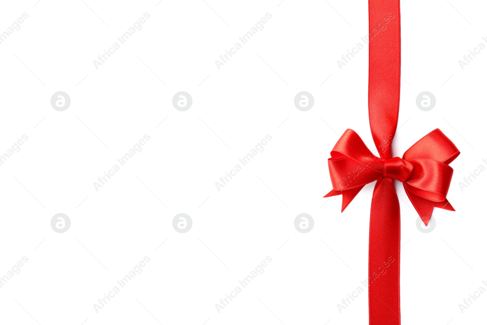 Photo of Red ribbon with bow on white background. Festive decoration