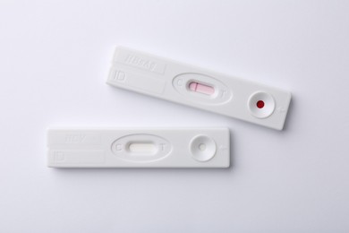 Photo of Two disposable express tests on white background, top view