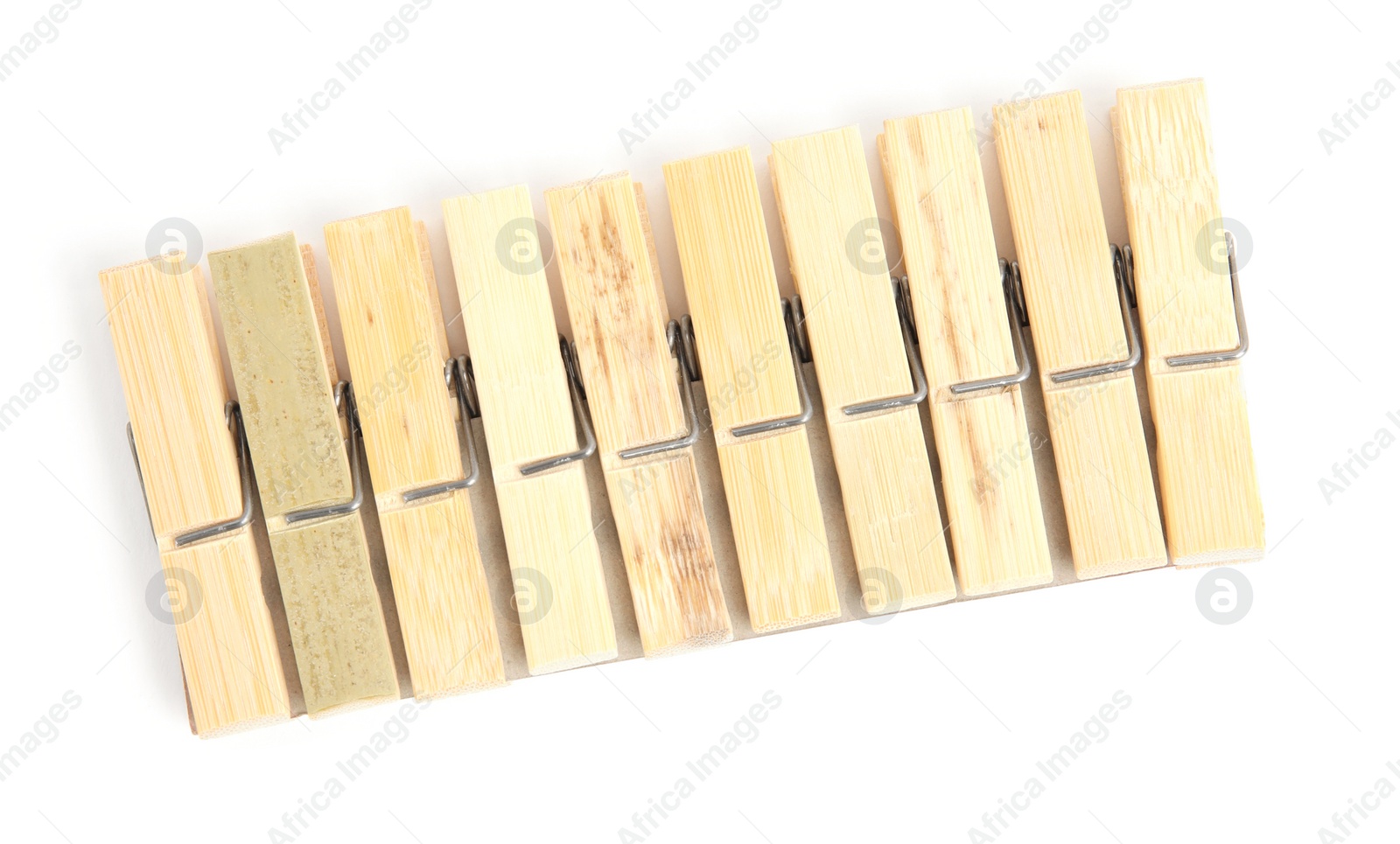 Photo of Set of wooden clothespins on white background, top view