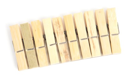 Photo of Set of wooden clothespins on white background, top view