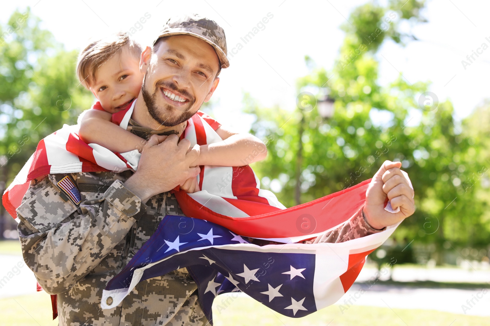 Photo of American soldier with his son outdoors. Military service