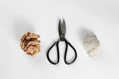 Rock, paper and scissors on white background, top view