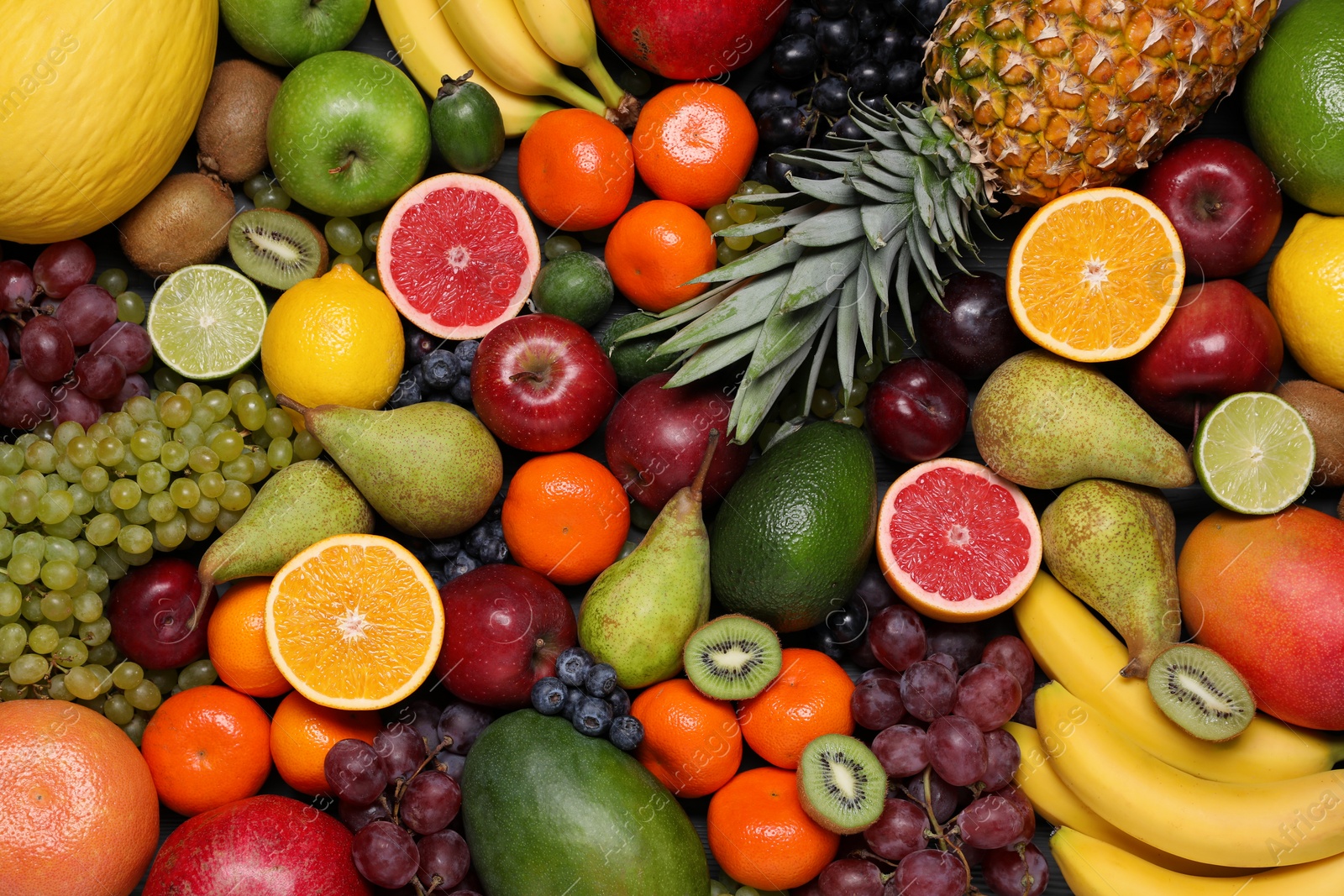 Photo of Different ripe fruits and berries as background, top view