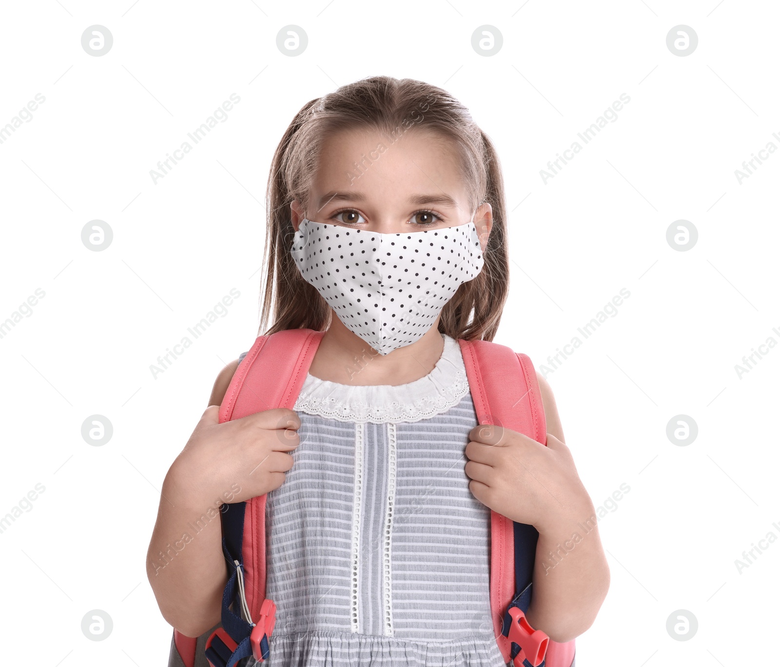 Photo of Little girl wearing protective mask with backpack on white background. Child safety