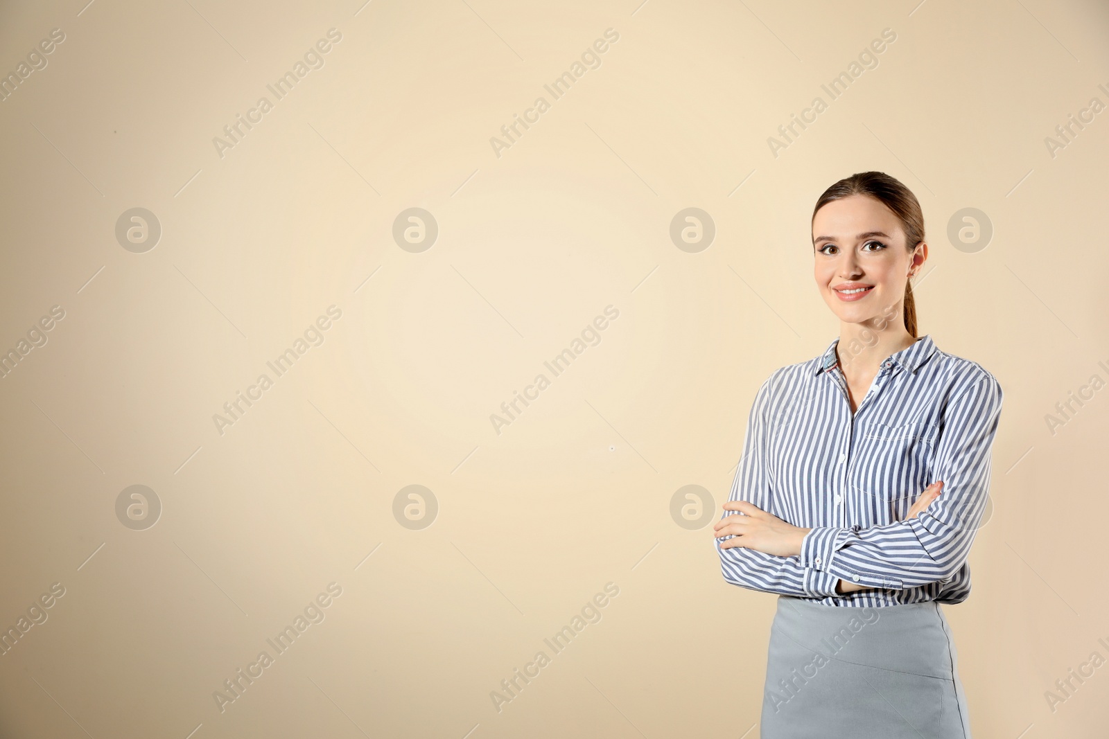 Photo of Portrait of young female teacher on beige background. Space for text