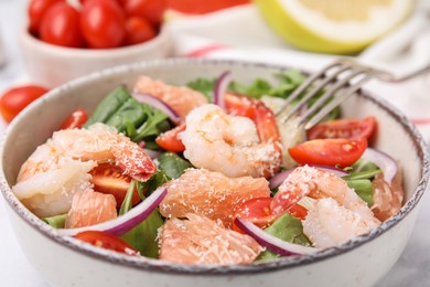 Delicious pomelo salad with shrimps on table, closeup view