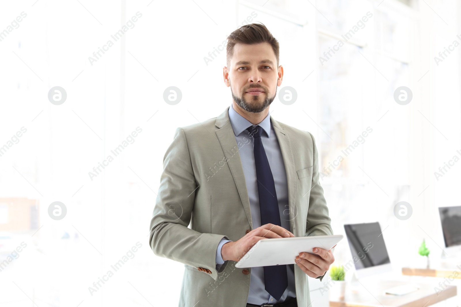 Photo of Male lawyer working with tablet in office