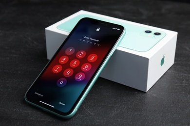 MYKOLAIV, UKRAINE - JULY 10, 2020: New modern Iphone 11 with numpad for entering passcode near box