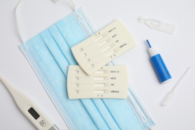 Photo of Disposable express test kit for hepatitis on white background, flat lay