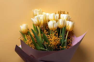 Photo of Bouquet with beautiful tulips and mimosa flowers on yellow background, top view