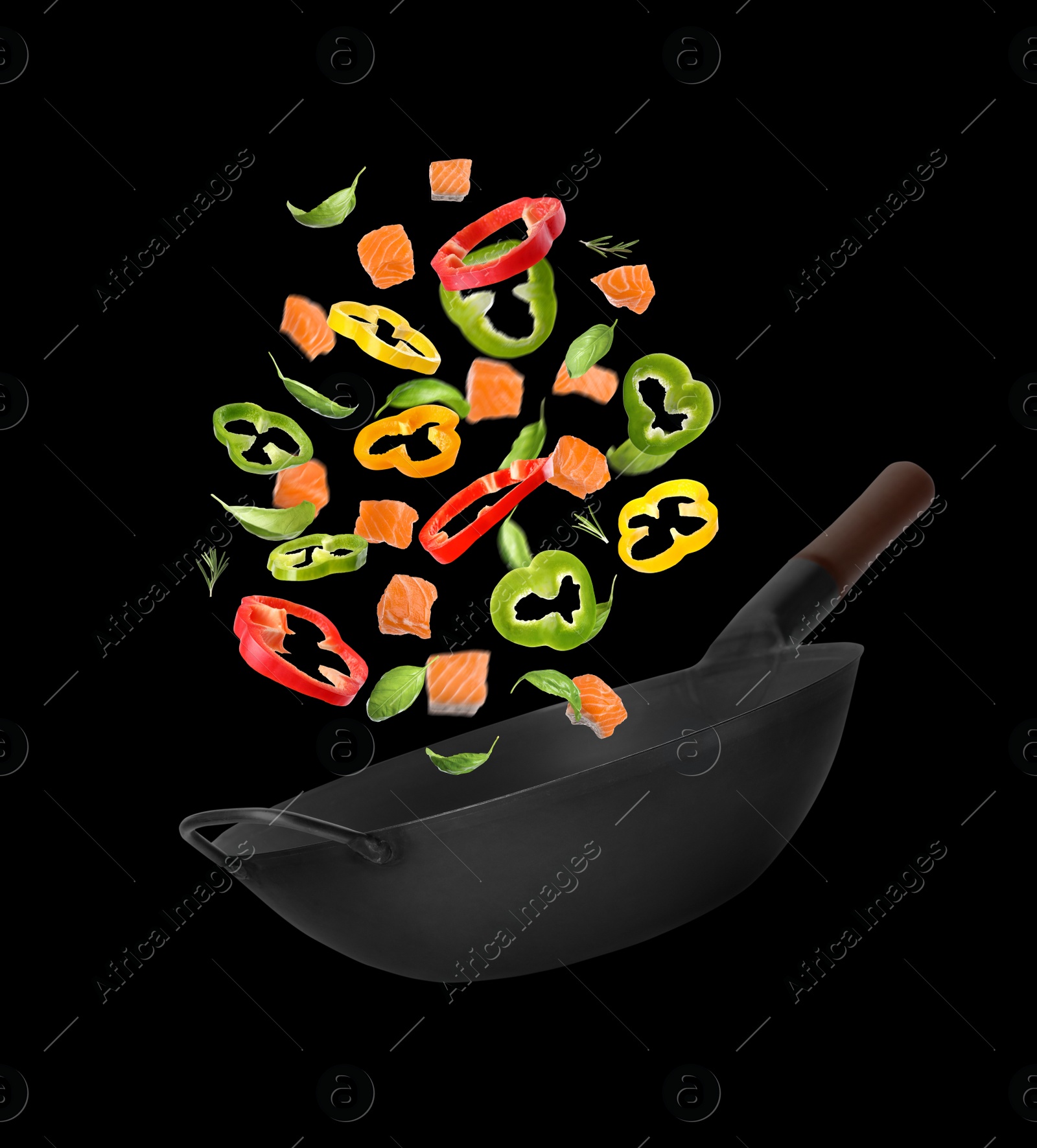 Image of Different tasty ingredients falling into wok on black background