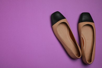 Photo of Pairnew stylish square toe ballet flats on purple background, flat lay. Space for text