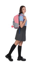 Teenage girl in school uniform with backpack on white background