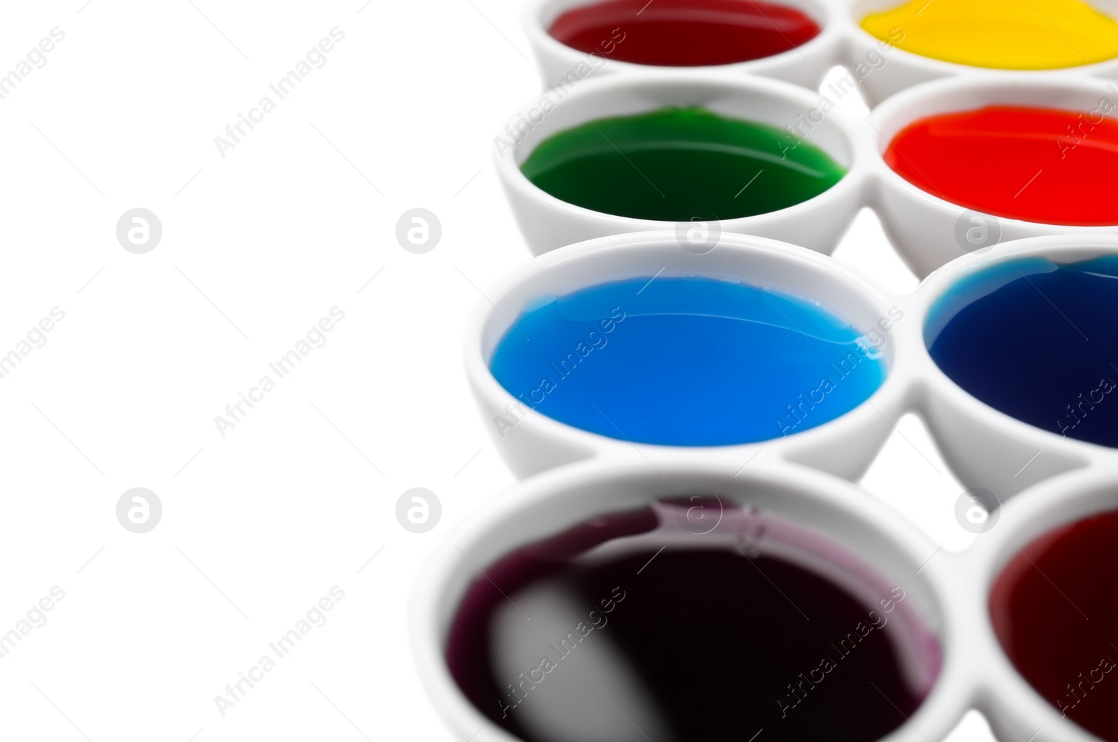 Photo of Bowls with many different food coloring on light grey table, closeup. Space for text