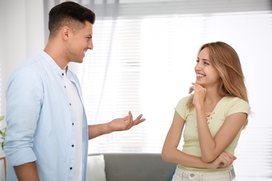 Photo of Man and woman talking in living room